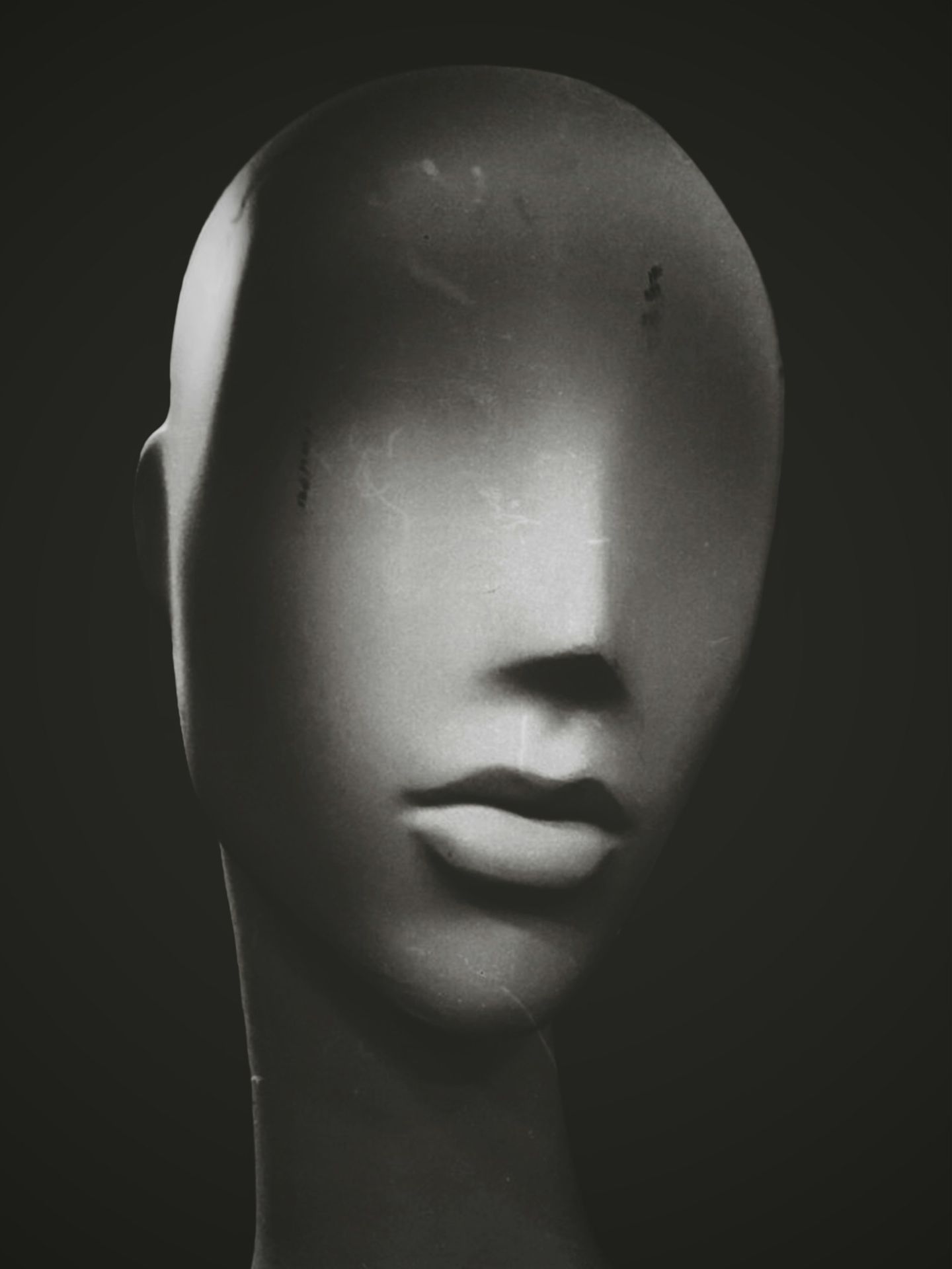 a black and white photo of a mannequin's head